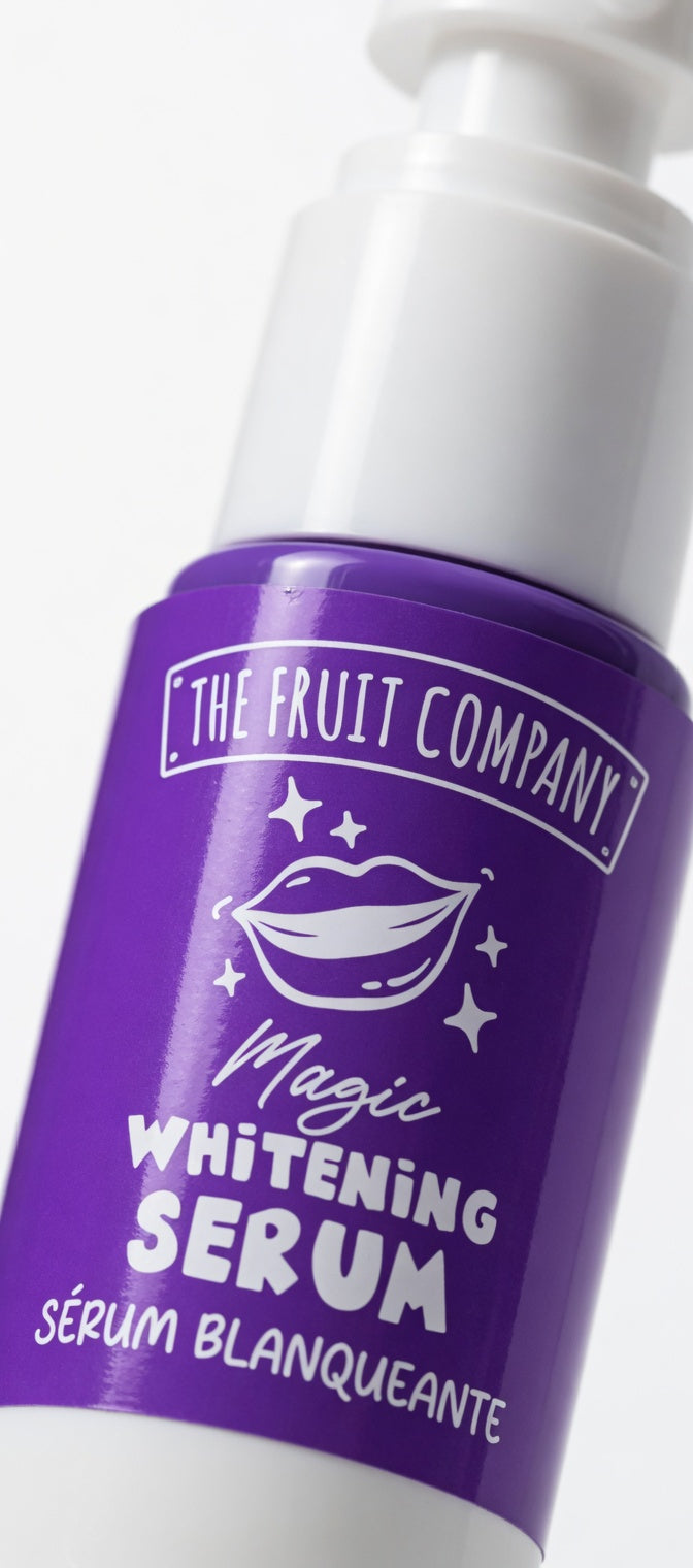 Purple serum bottle with white cap labeled 'The Fruit Company Magic Whitening Serum' on a white background
