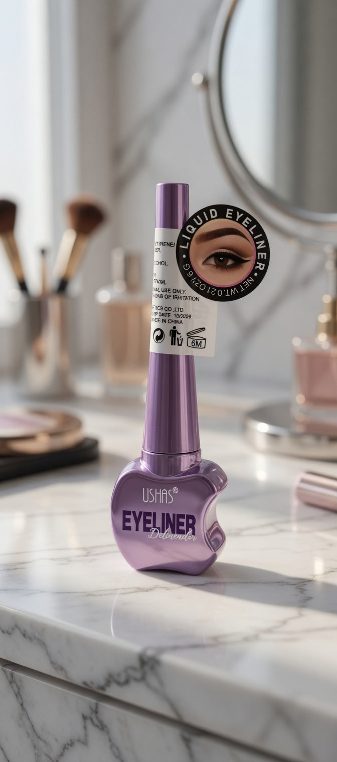 L'Oreal eyeliner bottle on a marble countertop with makeup brushes in the background