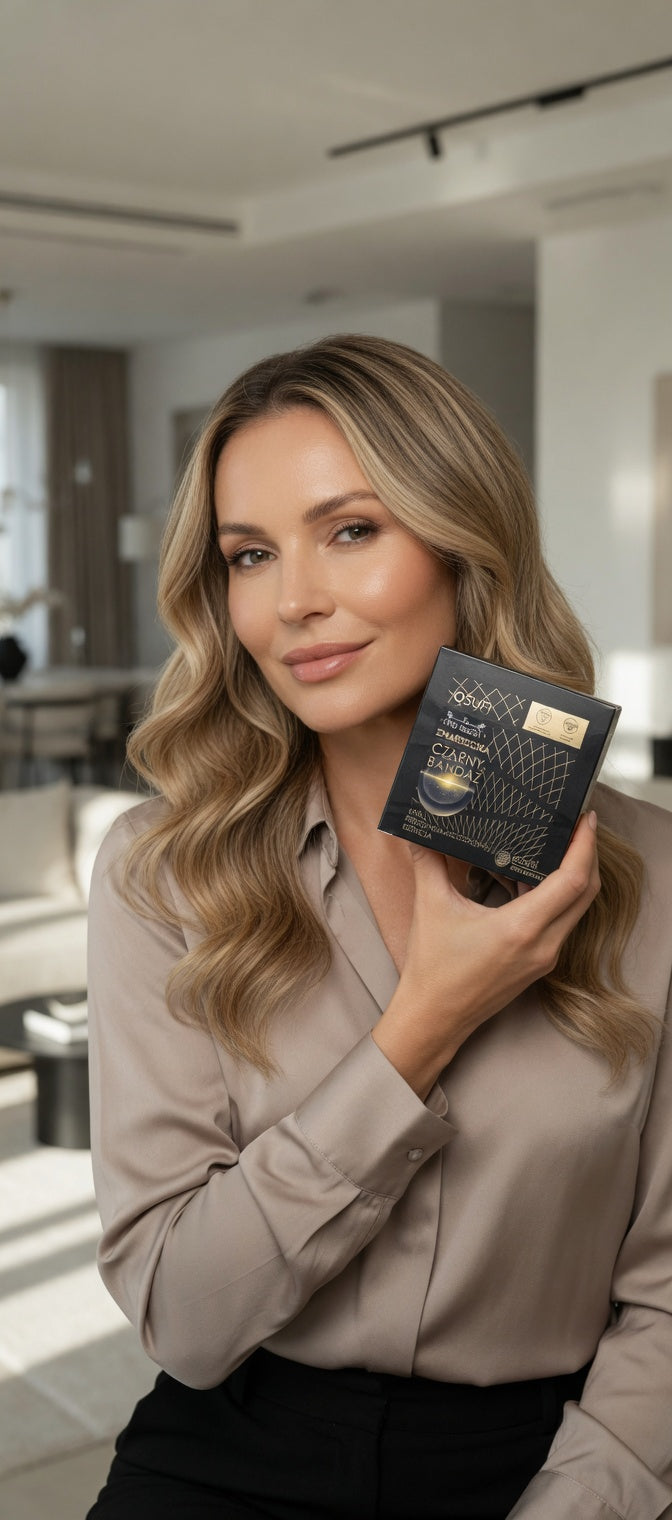 Woman holding a black leather wallet in a modern interior setting