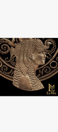 Bronze-colored emblem of a pharaoh with intricate details on a black background, featuring the brand 'La Mia'.