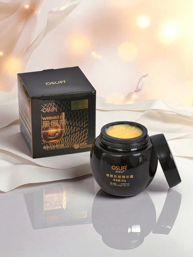 Black jar of cream with open lid and packaging on a reflective surface with soft lighting